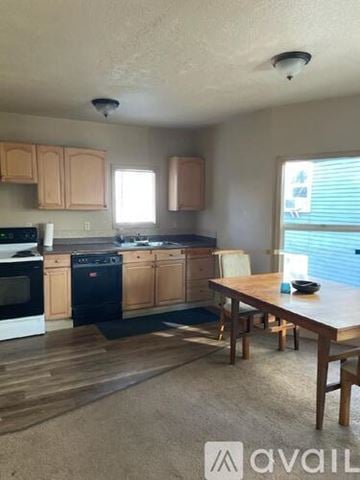 Portland apartment for rent - A kitchen with wooden cabinets and a dining table.