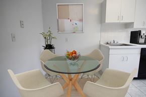 Brookline apartment for rent - a kitchen and dining room with a glass table and chairs