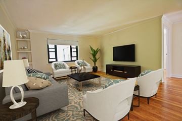 Brookline apartment for rent - a living room with white furniture and a tv