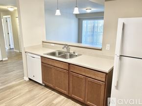 Spokane apartment for rent - A kitchen with a white stove and wooden cabinets.