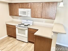 Spokane apartment for rent - A long hallway with white doors and wood floors.