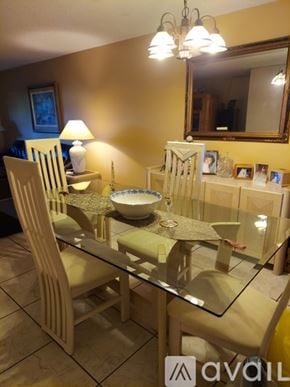 Miramar apartment for rent - A dining room with a glass table and chairs.
