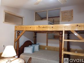 Elkhart apartment for rent - A bedroom with a wooden bunk bed and a single bed underneath.