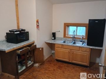 Elkhart apartment for rent - A kitchen with wooden cabinets and a granite countertop.