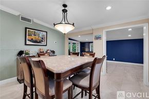 Miami house for rent - A dining room with a table set for six.