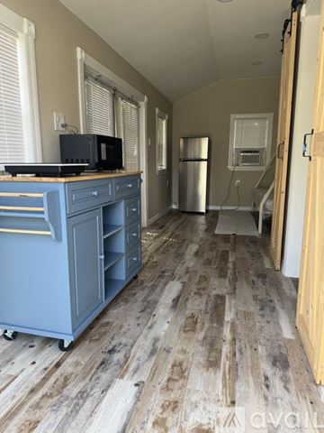Port St. Lucie apartment for rent - A kitchen with a blue cabinet and a TV on top of it.
