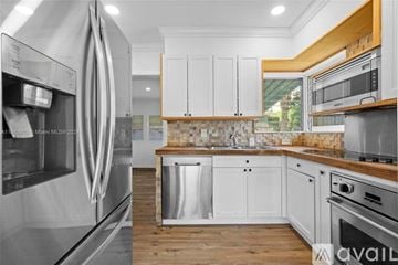 Key Biscayne house for rent - A modern kitchen with stainless steel appliances and wooden accents.