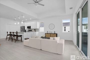 St. Petersburg house for rent - A modern living room with a white couch and a dining table.