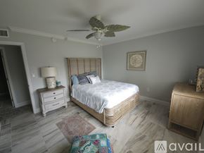 Naples condo for rent - A bedroom with a bed, nightstand, and a ceiling fan.