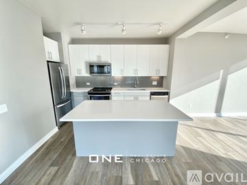 Chicago apartment for rent - A modern kitchen with a refrigerator, stove, and microwave.