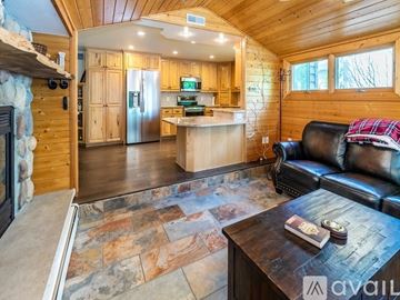 Prior Lake house for rent - A living room with brown leather furniture and a wooden coffee table.