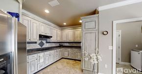 Gulf Shores apartment for rent - A kitchen with white cabinets and a marble floor.