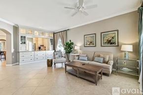 Land O' Lakes house for rent - A spacious living room with a ceiling fan and a coffee table.