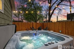 Dallas house for rent - A hot tub sits in the middle of a yard.