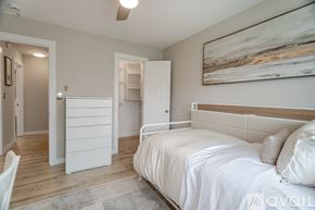 Lafayette house for rent - A bedroom with a large bed and a painting on the wall.