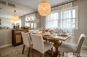 Lafayette house for rent - A dining room with a wooden table set for a meal.