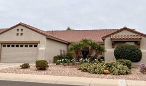 Surprise house for rent - A house with a red tile roof and a garage door.