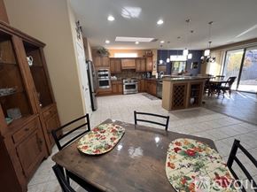 Surprise house for rent - A kitchen with a table set for two with floral tablecloths.