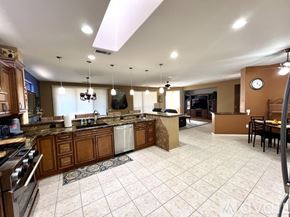 Surprise house for rent - A kitchen with a tile floor and a large island in the middle.