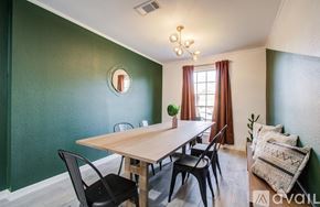 Houston house for rent - A dining room with a wooden table and chairs.