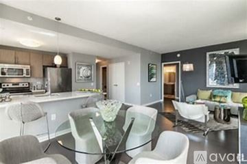 Jersey City apartment for rent - A modern kitchen with a glass table and white chairs.