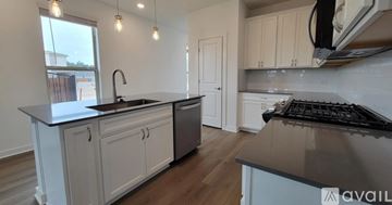 Liberty Hill apartment for rent - A kitchen with white cabinets and a black countertop.