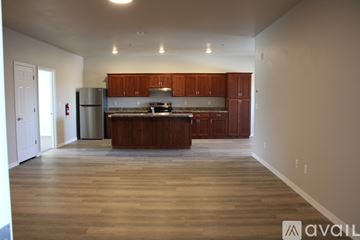 Twin Falls apartment for rent - A spacious kitchen with wooden cabinets and a refrigerator.