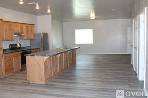 Twin Falls apartment for rent - A kitchen area with wooden floors and a dark brown island.
