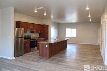 Twin Falls apartment for rent - A kitchen with wooden cabinets and a stainless steel refrigerator.