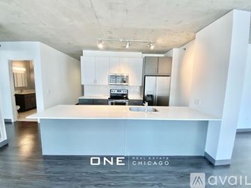 Chicago apartment for rent - A modern kitchen with white cabinets and a large island in the middle.