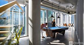 Chicago apartment for rent - A pool table in a room with a person standing behind it.