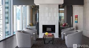 Chicago apartment for rent - A living room with a fireplace and grey couches.