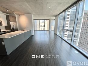 Chicago apartment for rent - A spacious, empty room with a view of the city skyline.