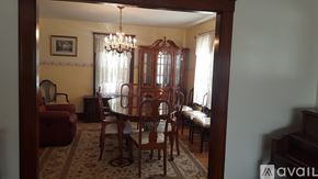 Norwood apartment for rent - A dining room with a chandelier, a table with chairs, and a framed picture on the wall.