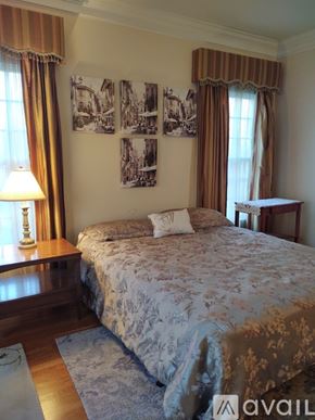 Ridgefield house for rent - A bedroom with a large bed and pictures on the wall.