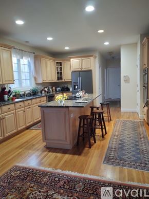 Ridgefield house for rent - A kitchen with wooden cabinets and a central island.