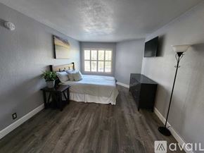 San Diego apartment for rent - A bedroom with a bed, nightstand, and lamp.