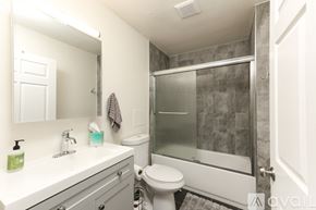 San Diego apartment for rent - A bathroom with a toilet, sink, and shower.