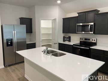 Chandler house for rent - A kitchen with a white countertop and black cabinets.