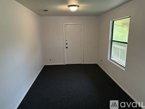 San Antonio apartment for rent - A room with a door, a window, and a carpeted floor.