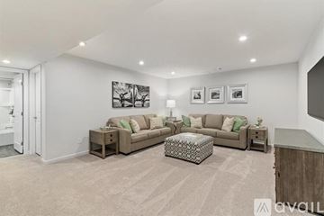 Sewickley house for rent - A living room with a large couch and a coffee table.