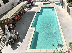 Los Angeles condo for rent - A pool with a table and chairs around it.
