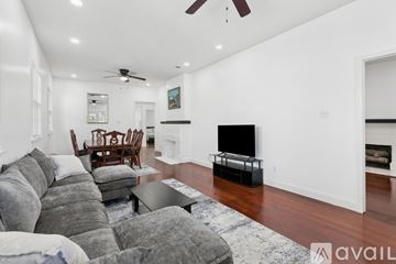 New Orleans apartment for rent - A living room with a grey sofa and a black television.