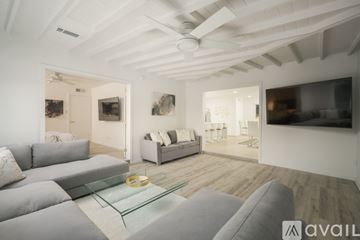Scottsdale house for rent - A modern living room with a grey sofa and a glass coffee table.