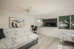Scottsdale house for rent - A bedroom with a large bed and a ceiling fan.