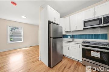 Chicago house for rent - A kitchen with a refrigerator, oven, and cabinets.