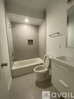 Philadelphia apartment for rent - A white bathroom with a toilet, sink, and bathtub.