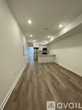 Philadelphia apartment for rent - A long hallway with wood floors and white walls.
