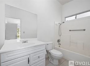 Moreno Valley apartment for rent - A white bathroom with a toilet, sink, and bathtub.