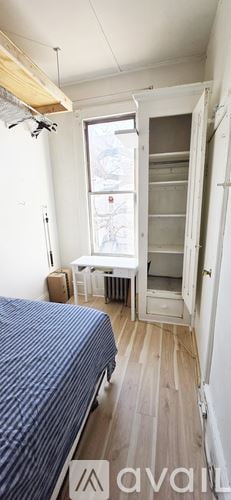 Brooklyn apartment for rent - A bedroom with a bed, nightstand, and pictures on the wall.
